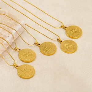 Gold zodiac coin necklaces featuring Leo and Gemini pendants on delicate chains