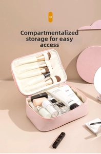 Pink waterproof makeup bag with interior brush slots and large storage compartments