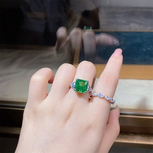 Detail of S925 silver ring featuring square emerald green zircon and pear cut band
