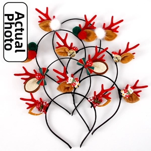 Detail view of assorted Christmas reindeer antler headbands with bells and bows