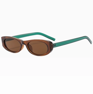 Dettaglio occhiali da sole ovali cat-eye con lenti marroni e stanghette verdi trasparenti