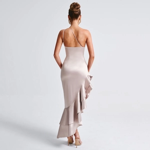 Detail of champagne satin dress featuring asymmetric straps and ruffled hem design