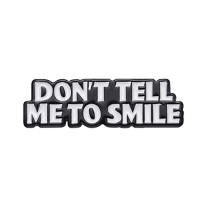 Creative enamel pin with Don't Tell Me To Smile text on black and white metal badge