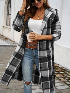 Detail of a long hooded flannel coat with black and white plaid pattern and button closure