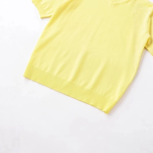 Short sleeve yellow knit sweater with V-neckline and ribbed hem details in flat lay view