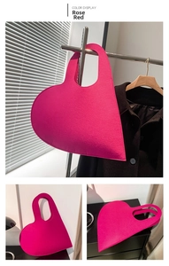 Detailed view of the rose red heart-shaped felt handbag with a modern matte finish