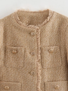 Close-up of khaki tweed jacket featuring golden buttons and fringed hem details