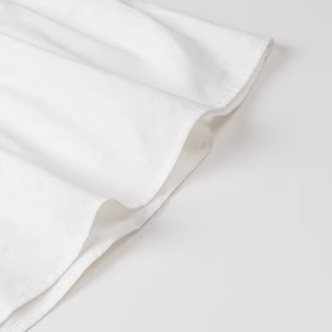 Close-up of white tube top hem featuring high-quality double-stitch sewing and soft fabric
