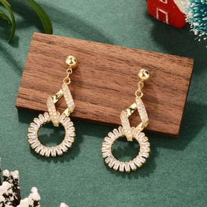 Elegant gold bow heart earrings with sparkling cubic zirconia on a green festive background