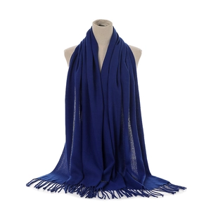 Detailed view of the soft navy blue cashmere-feel scarf with elegant fringe trim on a mannequin