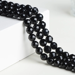 Faceted natural black agate loose beads for jewelry making on a white background