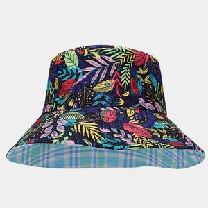 Detail of reversible sun hat with colorful leaf print and blue white checkered pattern