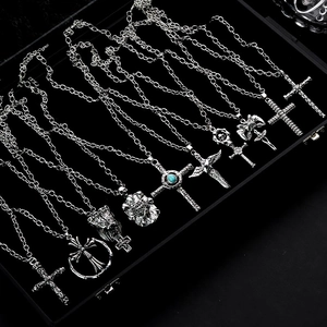 Gothic punk cross necklaces in vintage silver finish displayed on black velvet
