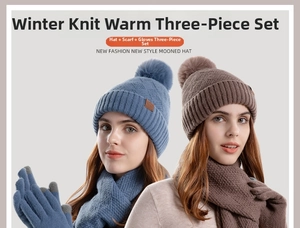 Close-up of winter knit set including a pom-pom hat, scarf and touchscreen gloves