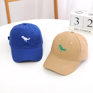 Close-up of kids' baseball caps with dinosaur embroidery in blue and khaki
