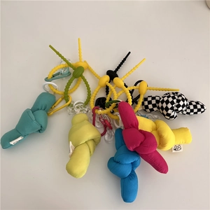 Close-up of colorful cloth knot charms with silicone rings and plastic clasps