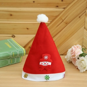 Detail of red plush Christmas hat featuring snowman doll and colorful snowflake sequins