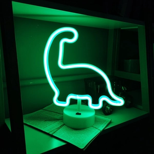 Green dinosaur neon light with white base and switch on wooden shelf as room decor