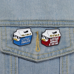 Funny blue and red cooler enamel pins with sunglasses on a denim jacket pocket