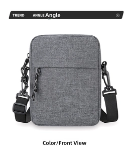 Front view of grey minimalist crossbody bag with textured fabric and woven zippers