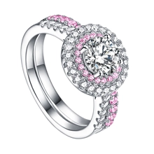 Detail of S925 sterling silver ring set featuring white and pink gemstones in a stack