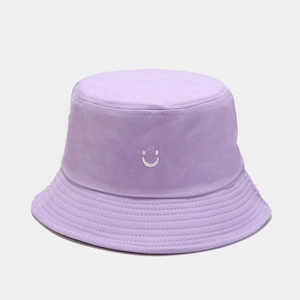 Detail of lilac cotton bucket hat featuring white smile embroidery and stitched wide brim