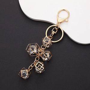 Golden lobster clasp keychain with geometric hollow cubes and transparent crystals