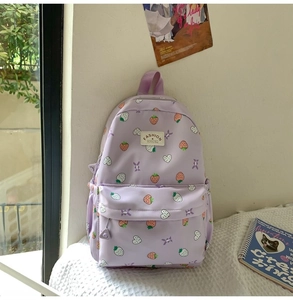 Close-up of cute purple strawberry print backpack on window seat with light尼龙 fabric