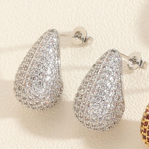 Macro shot of silver teardrop earrings with micro-paved sparkling cubic zirconia stones
