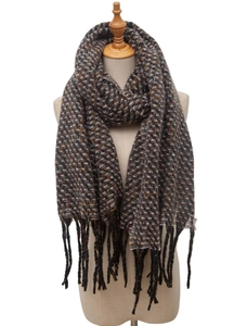 Close-up of knit winter scarf with herringbone pattern and colorful tassel detail