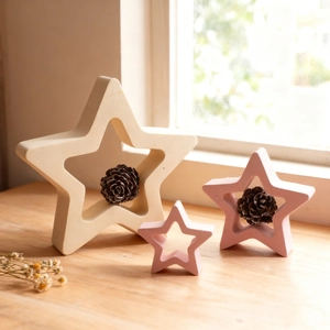 Three-piece star-shaped resin home ornaments in matte cream and pink with hollow center