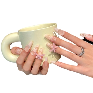 Pink and white gradient press-on nails with 3D bows and long trapezoid shape