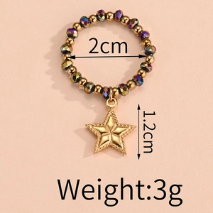 Detailed view of elastic beaded ring with golden star charm and size measurements