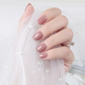 Detailed close-up of glossy dusty rose square-oval short press-on nails on hands