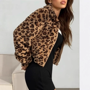 Close-up of fluffy leopard print faux fur texture on a cropped zip-up hooded jacket