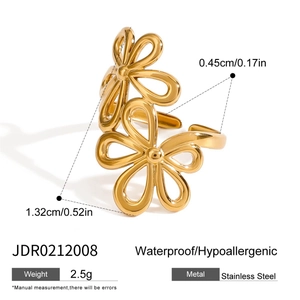 Detail view of gold floral open ring in stainless steel with hollow flower and leaf design