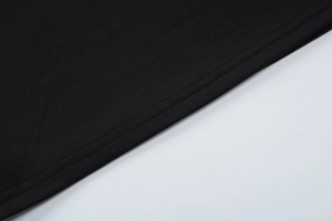 Detail view of the black plain-weave fabric with high-quality double-needle stitching