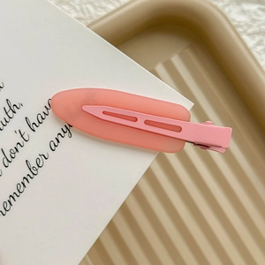 Close-up of pink frosted water-drop hair clip with matte texture on white card