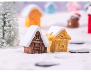 Macro detail of miniature resin snow cabins with wood texture for Christmas DIY decor