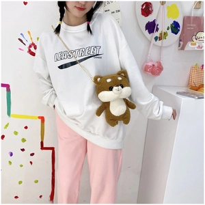 Cute Shiba Inu plush crossbody bag with gold chain strap shown on model in cozy interior