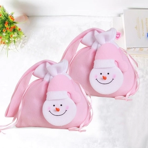 Detail of pink felt snowman Christmas gift bags with ribbon drawstrings for holiday candy