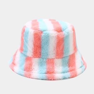 Detail of plush rainbow bucket hat showing soft faux fur texture and pastel stripes