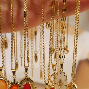 Detail of vintage 18K gold plated necklaces featuring natural stone pendants and diverse chains