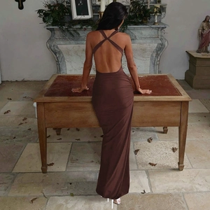 Detail view of backless dark brown bodycon dress with criss-cross straps and pleated fabric