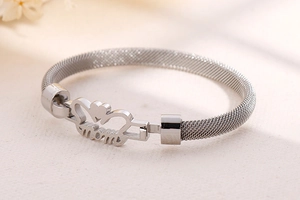 Detailed shot of silver mesh weave bracelet with heart-shaped MOM hollow charm