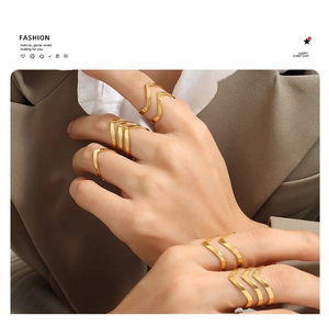 Detail of rose gold V-shaped stacked rings with polished finish for a layered look