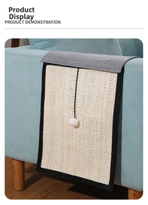 Detail showing sisal cat scratching mat with plush ball hanging on sofa armrest