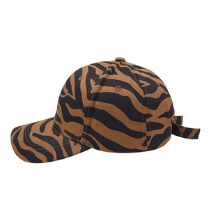 Detail of tiger print baseball cap showing durable twill fabric and curved brim