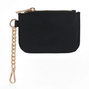 Detail of mini black nylon coin pouch with gold zipper and metal keychain clip