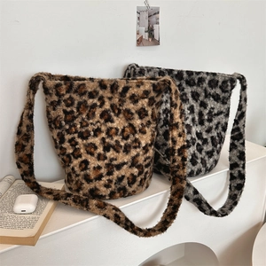 Close-up of fluffy leopard print bucket bags in brown and grey with soft plush texture